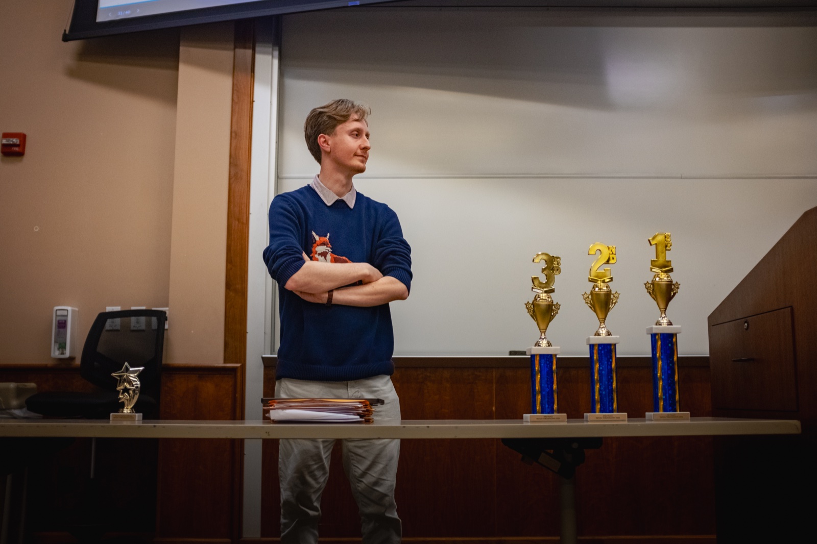 Dr. Iain Lampert with a table of national championship trophies